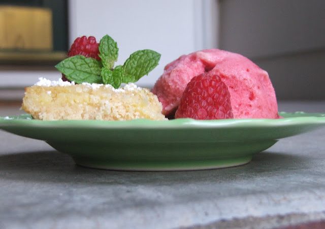 Green plate with a scoop of raspberry sorbet and a lime bar